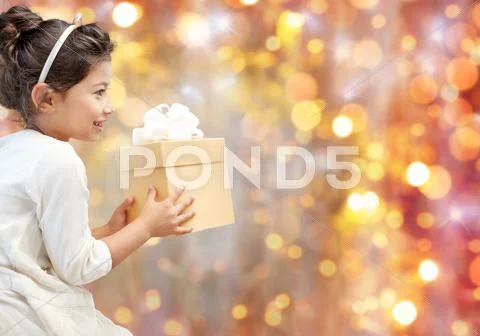 Smiling little girl with gift box Stock Photos