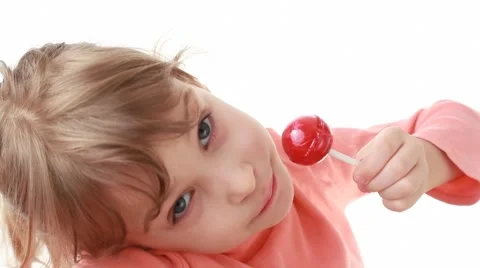 smiling little girl looks at camera and ... | Stock Video