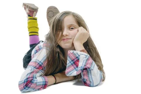Smiling little girl lying on the floor isolated on white background Stock Photos