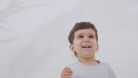 Smiling Little Kid Boy Jumping On Bed Stock Footage 244102165