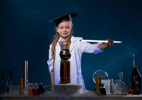Smiling little physicist conducting an experiment Image of smiling little ... Stock Photos
