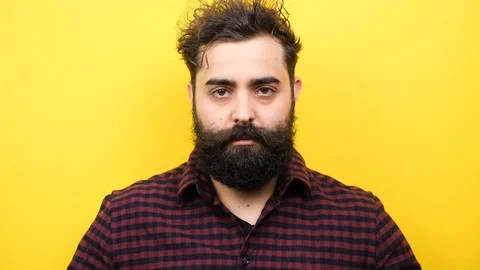 Smiling long bearded hipster puts his glasess on the face Stock Footage 86433242