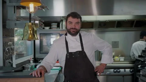 Smiling male Chef cook portrait in restaurant's commercial industry kitchen Stock Footage