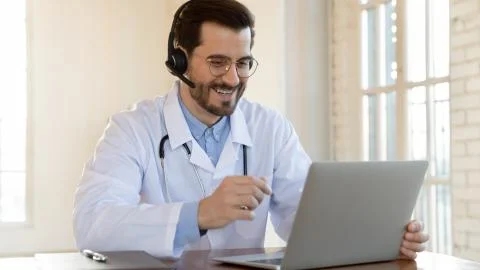 Smiling male doctor talk on video call with patient Stock Photos