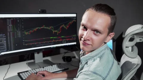 Smiling male programmer working late at the office with a computer screen Stock Footage 311828501