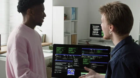 Smiling Male Programmers Shaking Hands at Computer Desk in Office Stock Footage 330668165
