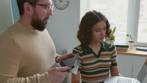 Smiling Male Programming Teacher Checking Girls Code and Giving Feedback Stock Footage 318715724