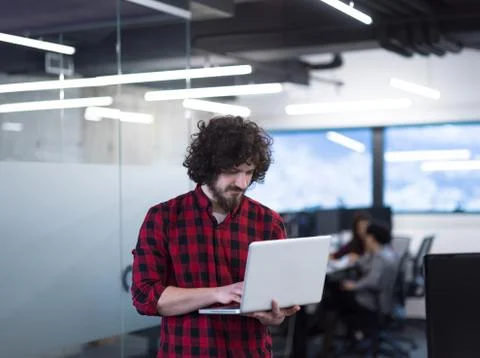 Smiling male software developer using laptop Stock Photos