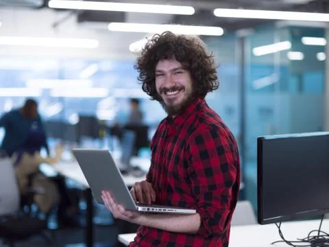 Smiling male software developer using laptop Stock Photos