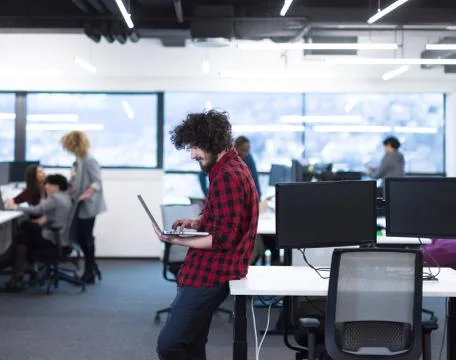 Smiling male software developer using laptop Stock Photos