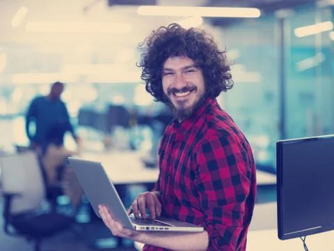 Smiling male software developer using laptop Stockfoto's