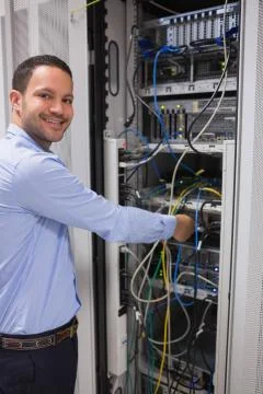 Smiling man adjusting server Stock Photos