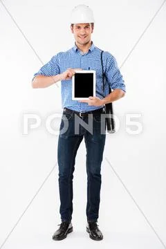 Smiling man architect in building helmet holding blank screen tablet Stock Photos