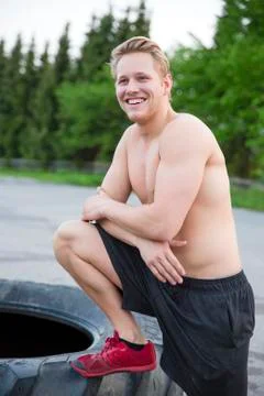 Smiling man with bare upper body rests outdoor Stock Photos