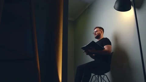 Smiling man with beard and glasses is having online video training holding a Stock Footage 150857822