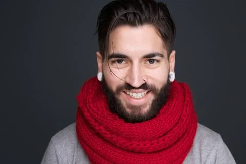 Smiling man with beard and red scarf Stock Photos