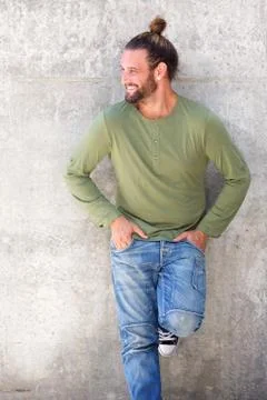 Smiling man with beard standing with hands in pockets Stock Photos