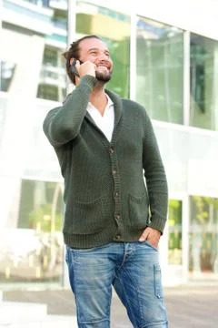 Smiling man with beard using mobile phone Stock Photos