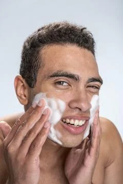 Smiling man caring of his problem skin Foto stock