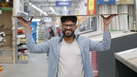 Smiling man choosing laminate flooring in a hardware store Stock-Footage 336965266
