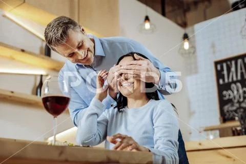 Smiling man closing womans eyes Stock Photos