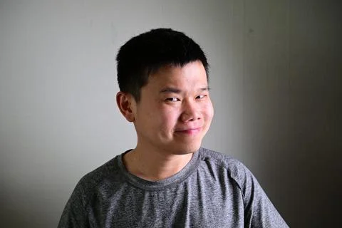 Smiling man with confident expression looking sideways on neutral background Photos