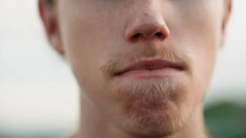 Smiling man delivers casual speech. Male with stubble talks comfortably outside Stock Footage 334946471