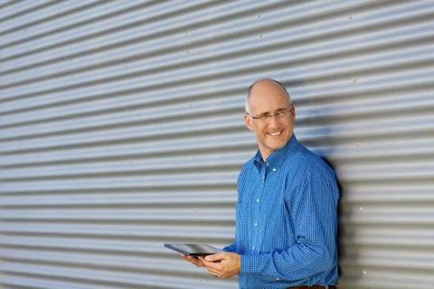 Smiling man with digital tablet Stock Photos