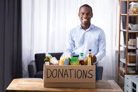 Smiling Man With Donation Box Stock Photos