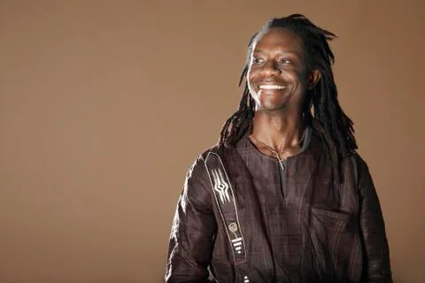 Smiling Man With Dreadlocks Looking Away Stock Photos