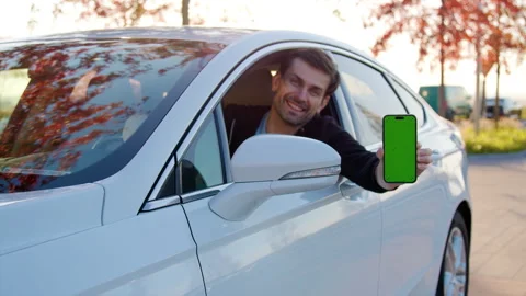 Smiling man driver shows car sharing app on smartphone Stock Footage 300590196