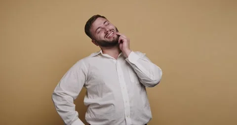 Smiling man enjoys a lighthearted conversation while posing with confidence.. Stock-Footage 329110319