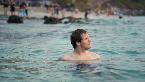 Smiling Man Floating in Crystal Clear Water of Tropical Island Stock Footage 126258547