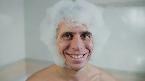 Smiling man in a foam wig Stock Footage 163718520