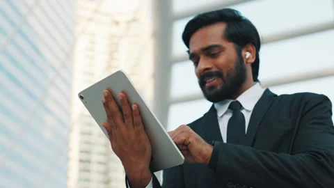 Smiling man in formalwear using modern multimedia device Stock Footage 304221922