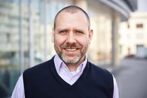 Smiling man in front of the building Stock Photos