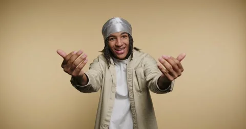 Smiling man gestures and shows emotions on a plain background in a studio Video stock 331989727