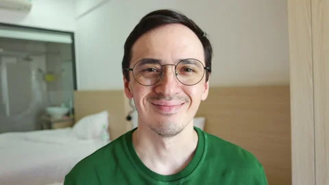 Smiling man with glasses looking at camera Video stock 337366701