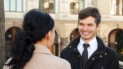 The smiling man has a nice conversation with a woman Stock Footage 83177042