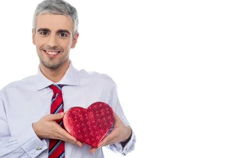 Smiling man holding a gift box Stock Photos