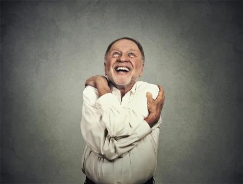 Smiling man holding hugging himself Stock Photos