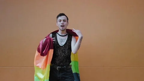 Smiling man of the lgbt community dancing with the gay flag Stock Footage 192077193