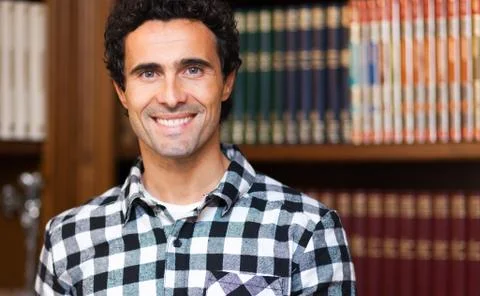 Smiling man in a library Stock Photos