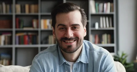 Smiling man look at camera talk make videocall at home Stock Footage 125132595