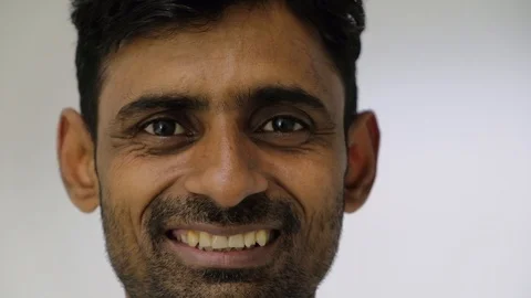 Smiling man looking at camera when suddenly his expression changes to remorse ov Stock Footage 100051643