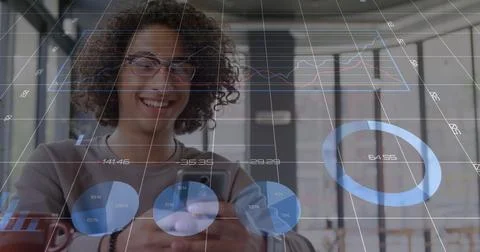 Smiling man looking down at smartphone in coworking space, with data overlays Stock Photos