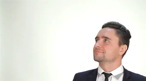 Smiling man looking up on isolated white background Stock Footage 56276692
