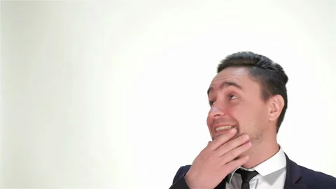 Smiling man looking up on isolated white background Stock Footage 252651496