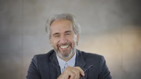 Smiling man looking t camera and taking off glasses. Businessman with grey hairs Stock Footage 164461544