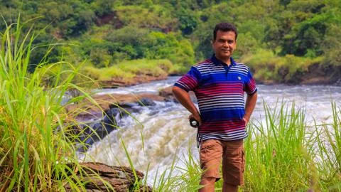 Smiling man looking towards camera. Standing on the edge of the River Nile. 스톡 사진